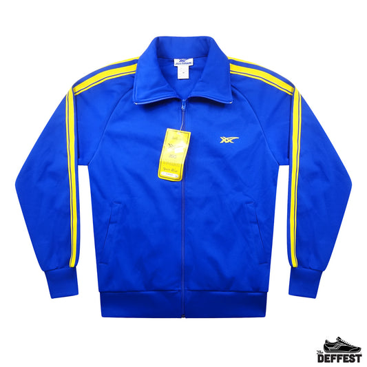 A royal blue vintage asics tiger track jacket with yellow stripes on the shoulders and down the sleeves, featuring a zip-up front, a small yellow logo on the left chest, and a yellow hangtag still attached. The jacket is displayed flat against a white background.